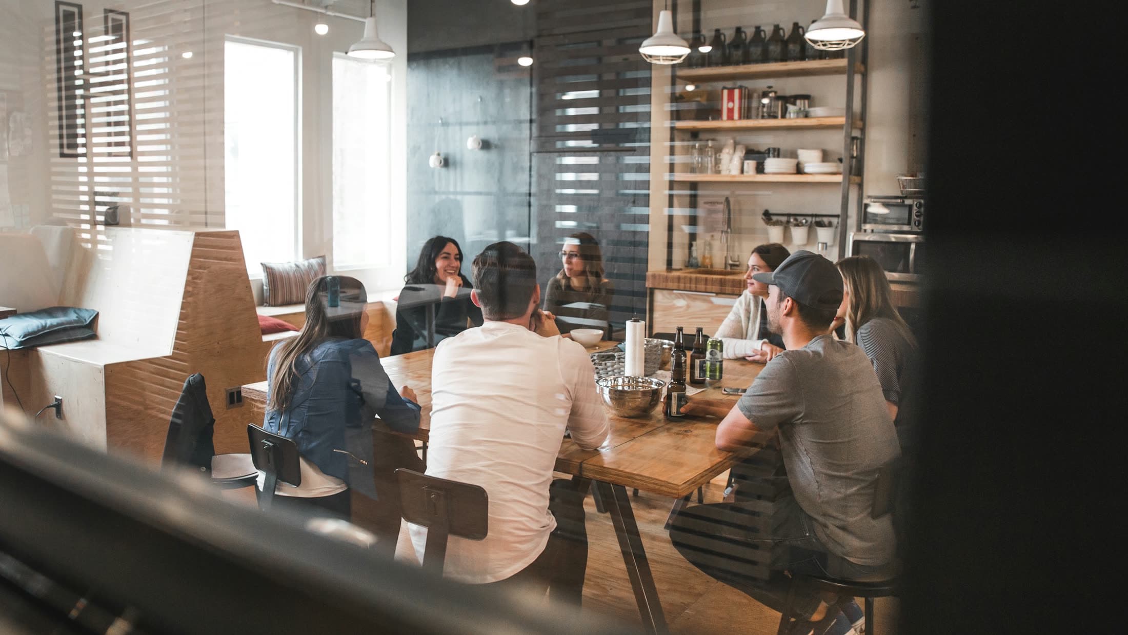 Bright meeting room with a long white table and black chairs